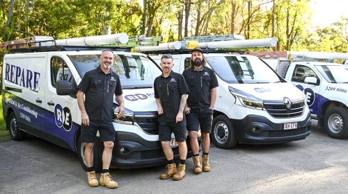 Electrician from REPARE fitting a new photoelectric unit during smoke alarm installation Loganholme upgrade work.